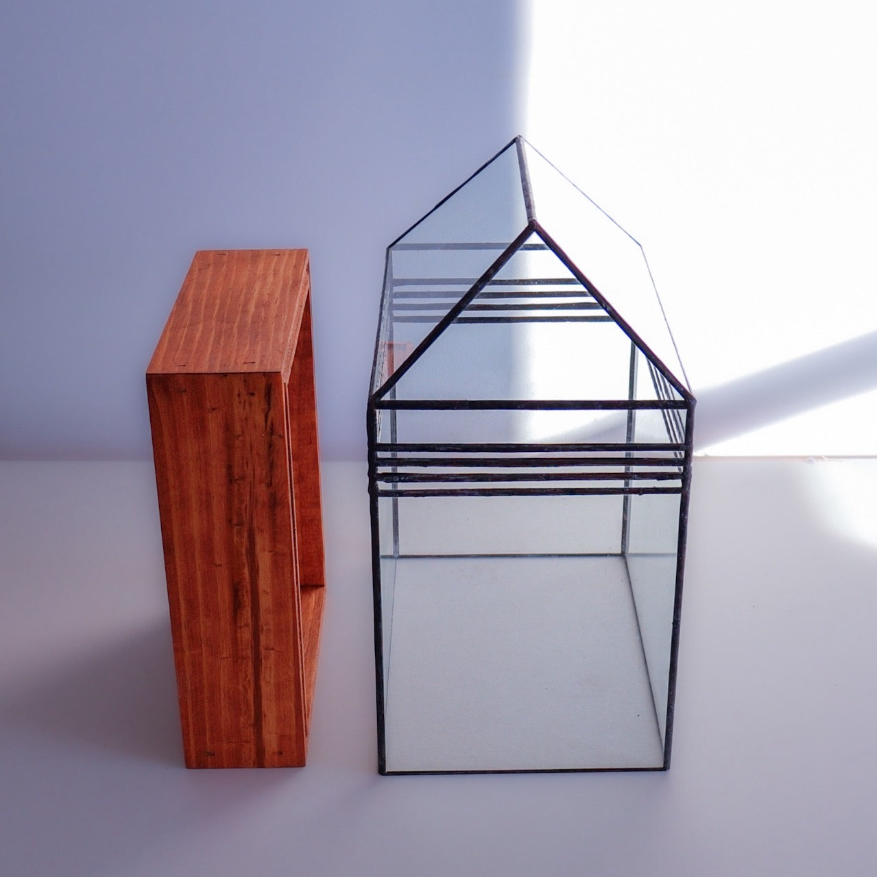 A stained glass terrarium with a removable top. For plants and displays