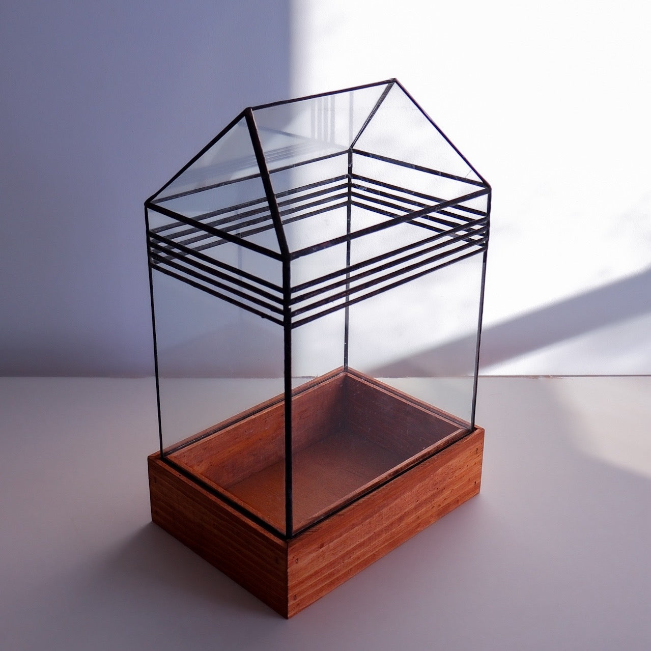 A stained glass terrarium with a cool line design.