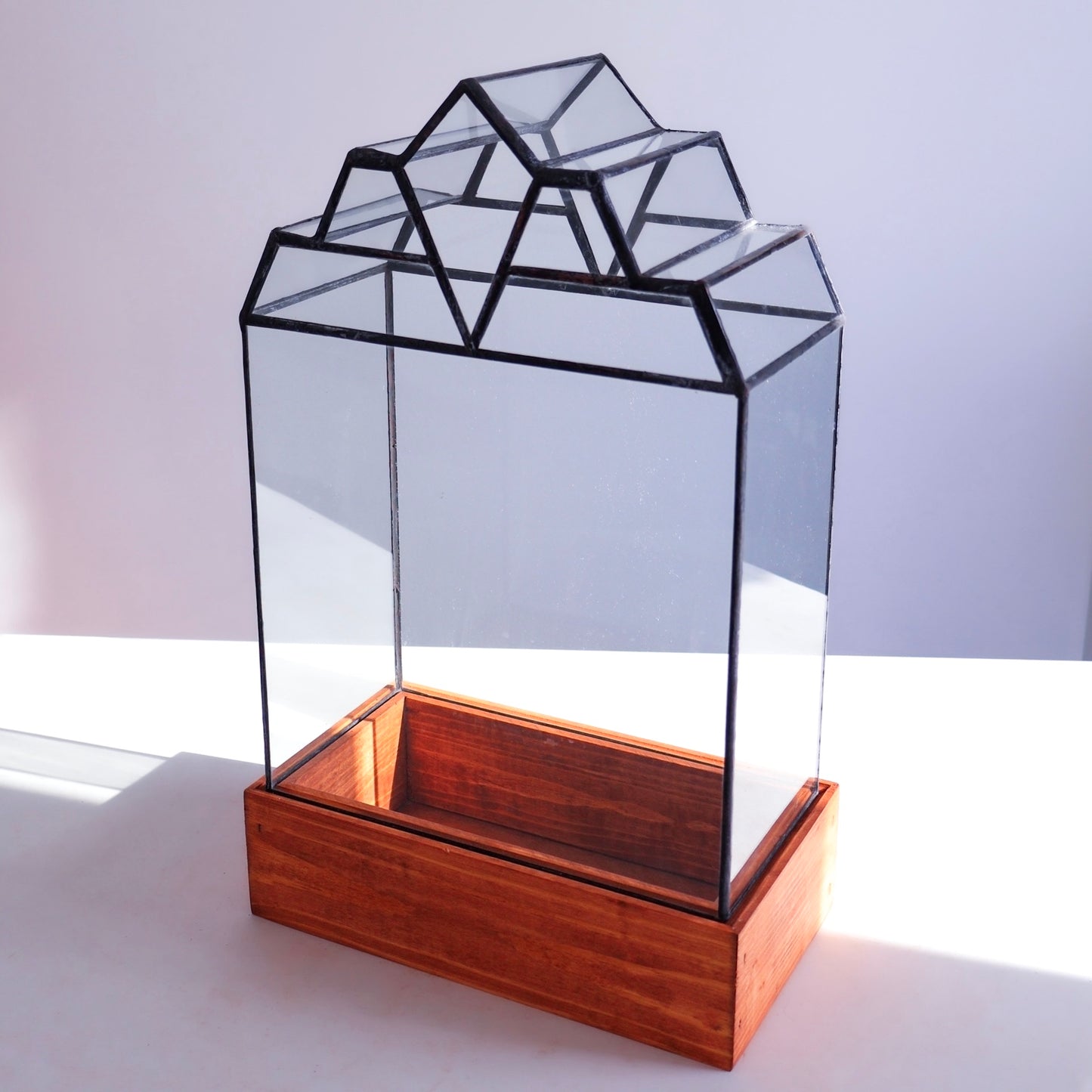 A Stained Glass Terrarium with a beautiful wood base.