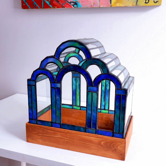 Stained glass terrarium on a wooden base. 