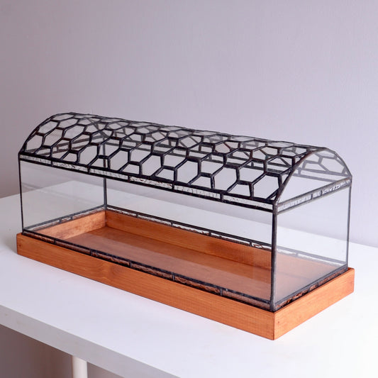 Stained Glass display case with honeycomb pattern on wooden base on a white surface